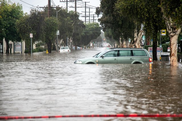 Abandoned cars are left in a flooded street in east Santa Barbara, California, January 9, 2023. (Photo by Erica Urech/Reuters)
