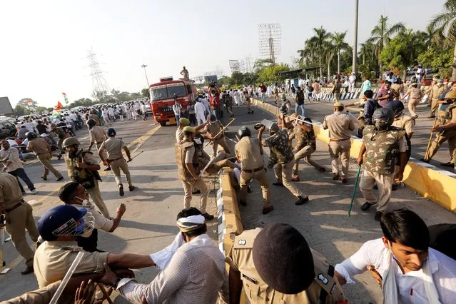 Police officers disperse demonstrators during a protest after the death of a rape victim, in Noida, India, October 3, 2020. (Photo by Adnan Abidi/Reuters)