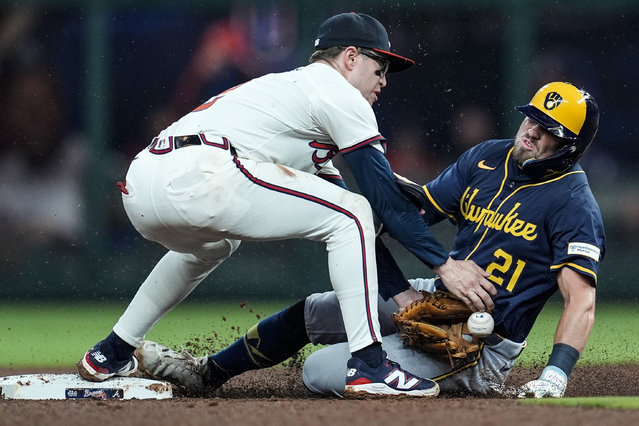 Milwaukee Brewers' Caleb Durbin (21) steals the base against Atlanta Braves shortstop Nick Allen (2) in the fifth inning of a baseball game, Tuesday, August 5, 2025, in Atlanta. (Photo by Mike Stewart/AP Photo)