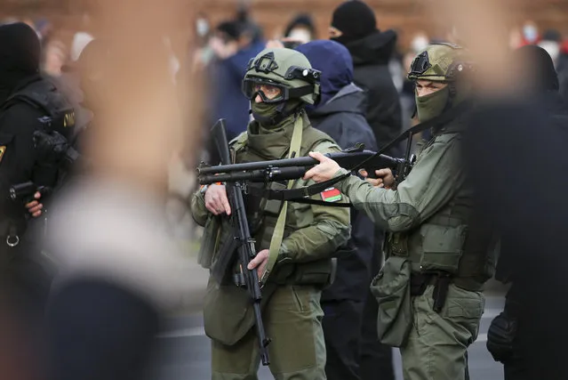 Armed police block demonstrators during an opposition rally to protest the official presidential election results in Minsk, Belarus, Sunday, November 1, 2020. (Photo by AP Photo/Stringer)