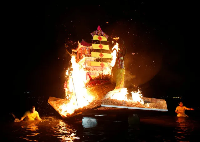 Devotees set adrift a burning paper dragon boat symbolising the sending away of misfortune and bad luck during the final day of the nine-day Taoist Nine Emperor Gods festival in Singapore October 9, 2016. (Photo by Edgar Su/Reuters)
