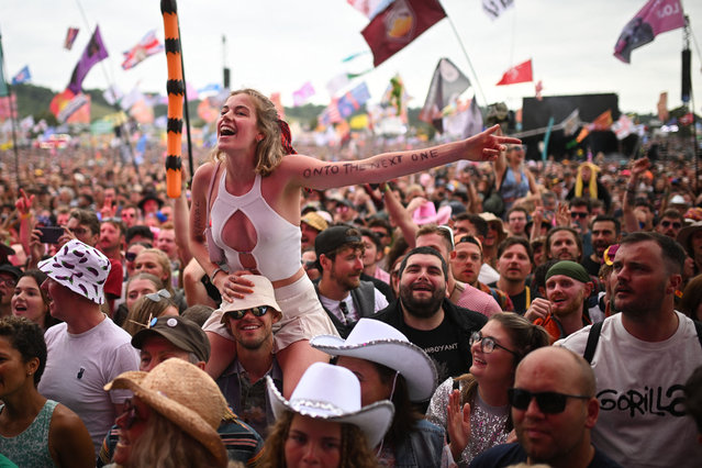 A festivalgoer enjoys the fifth day of the Glastonbury festival at Worthy Farm in the village of Pilton in Somerset, southwest England, on June 30, 2024. The festival takes place from June 26 to June 30. (Photo by Oli Scarff/AFP Photo)