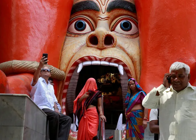Devotees are seen outside the temple of Hindu Lord Hanuman in New Delhi, India, April 5, 2018. (Photo by Cathal McNaughton/Reuters)