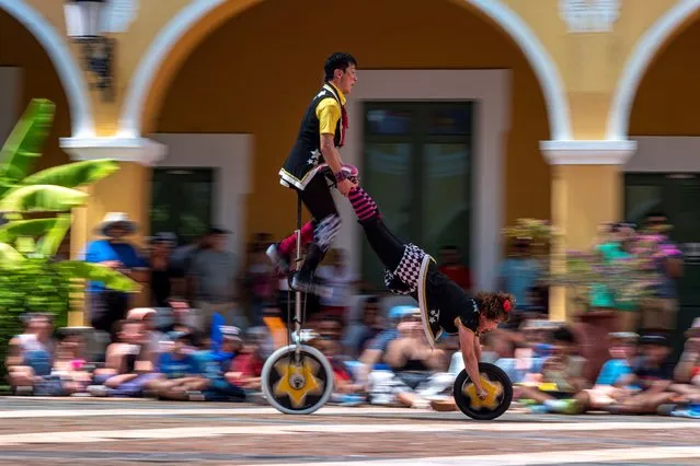 Cheeky and Daiki of the Witty Look unicycle riders of Japan perform during Puerto Rico Circo Fest in old San Juan on March 12, 2023. (Photo by Ricardo Arduengo/AFP Photo)
