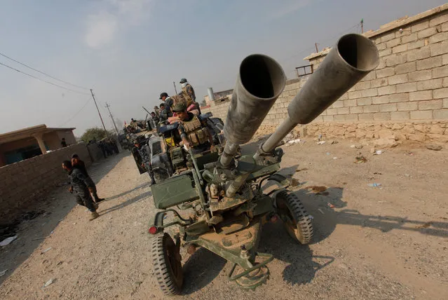 Federal police forces drive military vehicles during an operation against Islamic State militants in Qayyara, south of Mosul October 26, 2016. (Photo by Alaa Al-Marjani/Reuters)