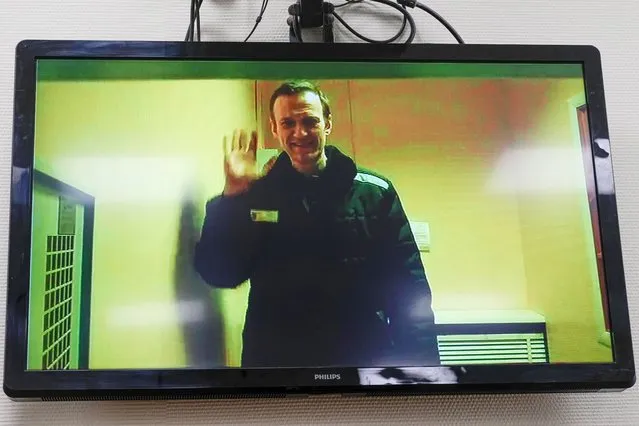 Russian opposition leader Alexei Navalny is seen on a TV screen, as he appears in a video link provided by the Russian Federal Penitentiary Service in a courtroom of the Basmanny Court in Moscow, Russia, on Wednesday, April 26, 2023. The court discussed procedure for a trial on new charges against Navalny. (Photo by Alexander Zemlianichenko/AP Photo)