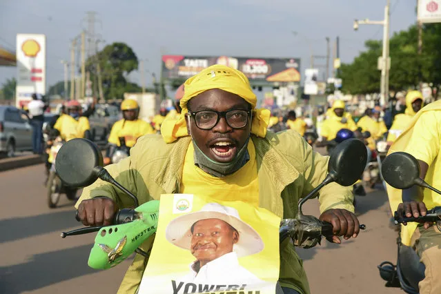 A supporter of Ugandan President Yoweri Kaguta Museveni celebrates in Kampala, Uganda, Saturday January 16, 2021, after their candidate was declared winner of the presidential elections. Uganda’s electoral commission says longtime President Yoweri Museveni has won a sixth term, while top opposition challenger Bobi Wine alleges rigging and officials struggle to explain how polling results were compiled amid an internet blackout. In a generational clash widely watched across the African continent, the young singer-turned-lawmaker Wine posed arguably the greatest challenge yet to Museveni. (Photo by Nicholas Bamulanzeki/AP Photo)