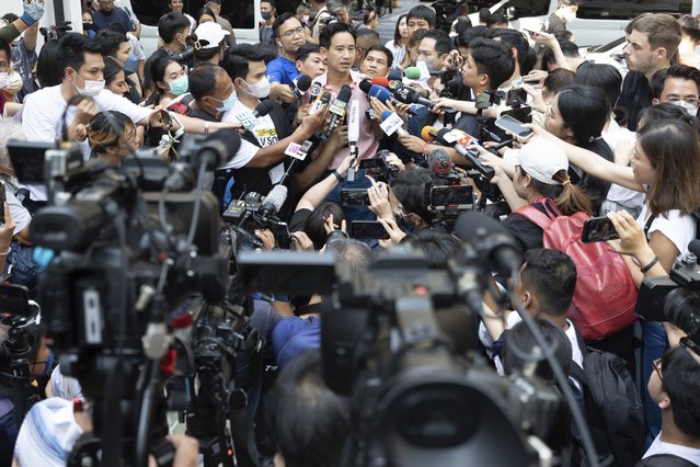 Leader of Move Forward Party Pita Limjaroenrat, rear center, talks to media after casting his vote during a general election at a polling station in Bangkok, Thailand, Sunday, May 14, 2023. Voters in Thailand were heading to the polls on Sunday in an election touted as a pivotal chance for change, eight years after incumbent Prime Minister Prayuth Chan-ocha first came to power in a 2014 coup. (Photo by Rapeephat Sitichailapa/AP Photo)