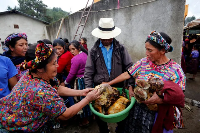 Women check meat to cook for the invitees to the wake of Claudia Gomez, a 19-year-old Guatemalan immigrant who was shot by a U.S. Border Patrol officer, at her home in San Juan Ostuncalco, Guatemala June 1, 2018. (Photo by Luis Echeverria/Reuters)