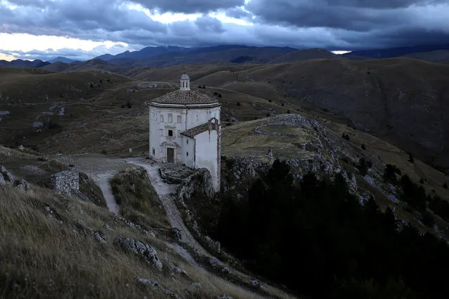 A church stands isolated from other buildings in the small town of Rocca Calascio, close to Santo Stefano di Sessanio in the province of L'Aquila in Abruzzo, inside the national park of the Gran Sasso e Monti della Laga, Italy, September 6, 2016. (Photo by Siegfried Modola/Reuters)