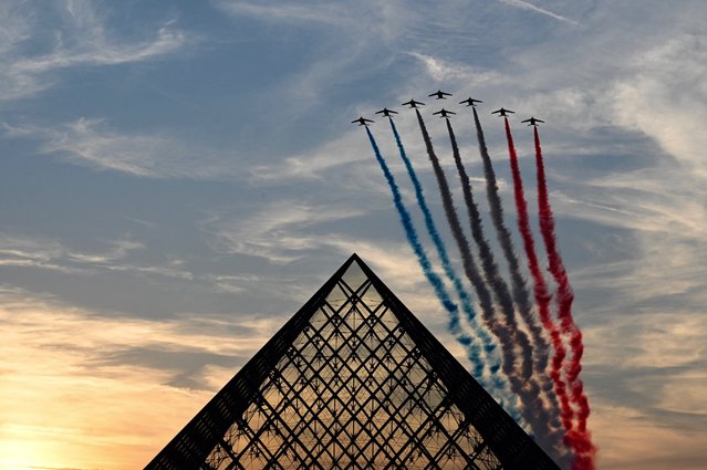 French Air Force Elite acrobatic flying team “Patrouille de France” performs over the Pyramide du Louvre designed by Chinese-US architect Ieoh Ming Pei, during the Paris 2024 Paralympic Games Opening Ceremony in Paris on August 28, 2024. (Photo by Christophe Delattre/AFP Photo)
