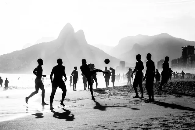 “The Beautiful game”. Rio: Ipanema, zamba, capirinhas and Soccer this are a few words to describe one of the most exotic, and beautiful cities, Rio De Janeiro where Cariocas (locals) take advantage of the beauty that nature gave them, and play sports on the beach like soccer, where passion for the beautiful game makes them one of the best. (Photo and caption by Julio Campos/National Geographic Traveler Photo Contest)
