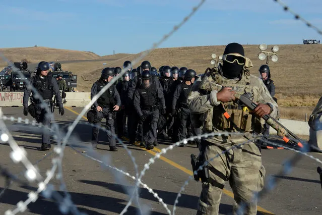 Police stand guard during a stand off with protesters on a bridge during a protest of the Dakota Access pipeline near the Standing Rock Indian Reservation near Cannon Ball, North Dakota November 6, 2016. (Photo by Stephanie Keith/Reuters)