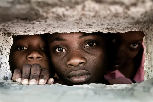 “Behind the Wall”. Pupils from the school of Degerme behind the wall of the school. Location: Abricots, Grand'Anse department of Haiti. (Photo and caption by Christophe Stramba-Badiali/National Geographic Traveler Photo Contest)