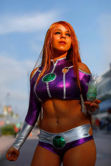 Emily of Chula Vista, California, dressed as Starfire, attends preview night before the opening of pop culture convention Comic Con International in San Diego, USA on Thursday, July 19, 2018. (Photo by Mike Blake/Reuters)