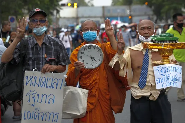 A Thai Buddhist monk (C) joins a rally calling to revoke the lese majeste law and release jailed protest leaders in Bangkok, Thailand, 13 March 2021. Thai police have arrested core protest leaders and some demonstrators on charges of lese majeste and sedition over their demonstrations calling to reform the monarchy. Thailand has been facing political turmoil amid months-long street protests calling for political and monarchy reforms. (Photo by Diego Azubel/EPA/EFE)