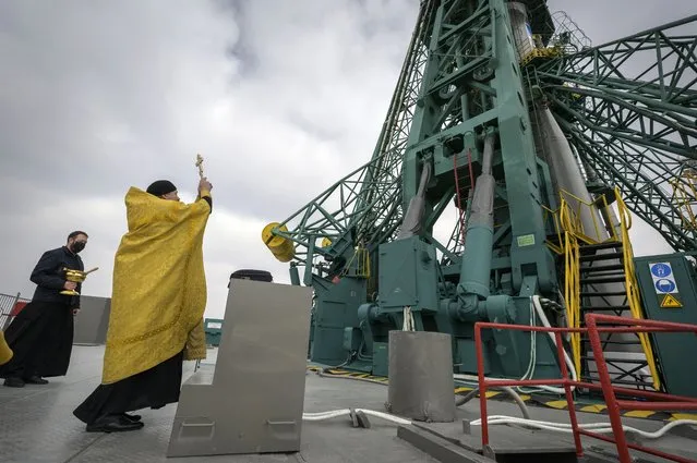 The Rev. Sergei, a Russian Orthodox priest, blesses the Soyuz rocket at the Baikonur Cosmodrome launch pad, Thursday, April 8, 2021 in Kazakhstan. Astronaut Mark Vande Hei and cosmonauts Pyotr Dubrov and Oleg Novitskiy are scheduled to launch aboard the Soyuz MS-18 spacecraft Friday, for rendezvous with the International Space Station. (Photo by Bill Ingalls/NASA via AP Photo)