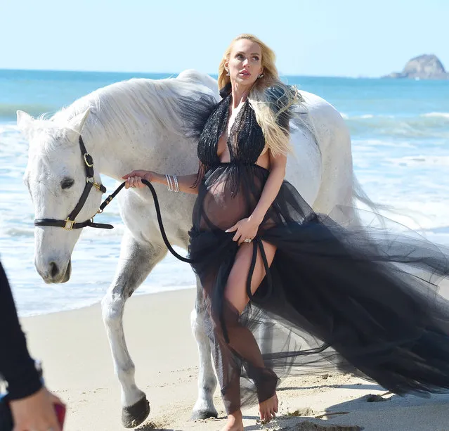 Christine Quinn shows off her growing baby bump while on set for a photoshoot on the sunny Malibu beaches alongside a white stallion on April 1, 2021. The star of the hit Netflix show, Selling Sunset, wore a black gown before changing looks into a yellow one. (Photo by TheImageDirect.com)