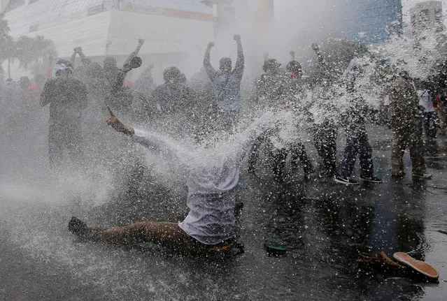 Protesters react as police spray water canon to disperse them during a rally calling for their right to self-determination in the Indonesian controlled part of Papua, in Jakarta, Indonesia, December 1, 2016. (Photo by Reuters/Beawiharta)