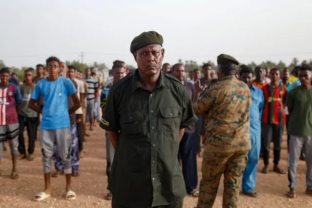 A Sudanese officer speaks to civilians recruited by the army as they take part in a military training in the Kassinger area of Sudan's Northern State on August 9, 2023. Four months into a battle both believed they would win, Sudan's army has lost its grip on Khartoum to paramilitaries, who are unable to declare victory and instead are accused of waging war on civilians. (Photo by AFP Photo/Stringer)