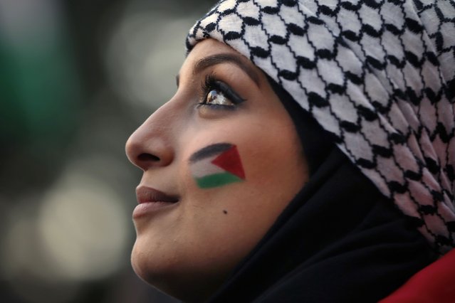 A Palestinian living in Lebanon painted Palestinian flags on her face during a march in support of Palestinians, in Beirut, Lebanon, Tuesday, May 18, 2021. (Photo by Bilal Hussein/AP Photo)