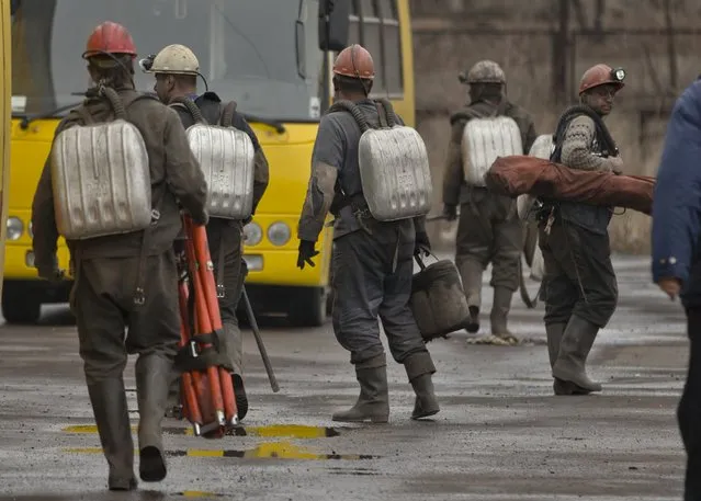 Ukrainian mining rescuers leave after taking part in the search for bodies of miners  killed in an explosion yesterday before dawn at more than 1,000 metres (3,200 feet) underground at the Zasyadko mine, in Donetsk, Ukraine, Thursday, March 5, 2015.Officials in a separatist rebel-held city in east Ukraine say the death toll from an accidental explosion at a coal mine has risen to 32, while one person still remains unaccounted for. (AP Photo/Vadim Ghirda)