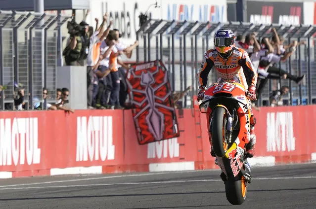 In this October 21, 2018, photo,  Spain's rider Marc Marquez celebrates after crossing the finish line to win the MotoGP Japanese Motorcycle Grand Prix at the Twin Ring Motegi circuit in Motegi, north of Tokyo. (Photo by Shizuo Kambayashi/AP Photo)