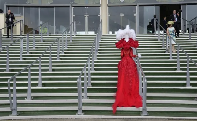 Debora Day in an ornate red outfit poses on the steps for photographers on the third day of the Royal Ascot horserace meeting, which is traditionally known as Ladies Day, at Ascot, England Thursday, June 17, 2021. (Photo by Alastair Grant/AP Photo)