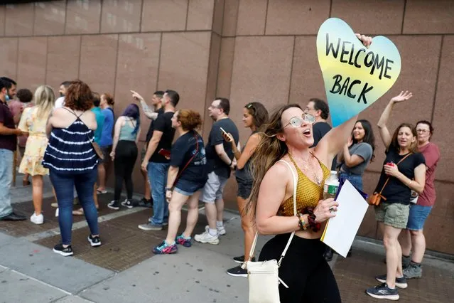A fan holds a sign as people queue to attend Foo Fighters' show, which required proof of vaccination to enter, at the Madison Square Garden, in New York City, U.S., June 20, 2021. (Photo by Andrew Kelly/Reuters)