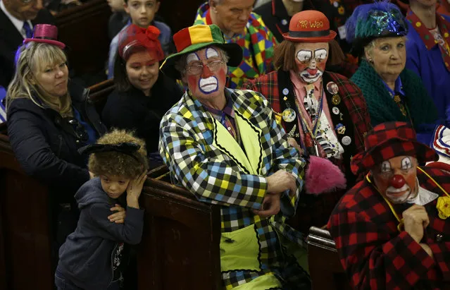Clowns and members of the public sit in the pews of the All Saints Church during the Grimaldi clown service in Dalston, north London, February 7, 2016. (Photo by Peter Nicholls/Reuters)