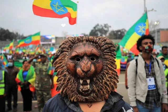 A masked man attends the pro-government rally to celebrate the second filling of the Great Renaissance Dam (GERD) being built on the Nile River and to condemn Tigray People Liberation Front (TPLF) at the Meskel Square in Addis Ababa, Ethiopia, July 22, 2021. (Photo by Tiksa Negeri/Reuters)