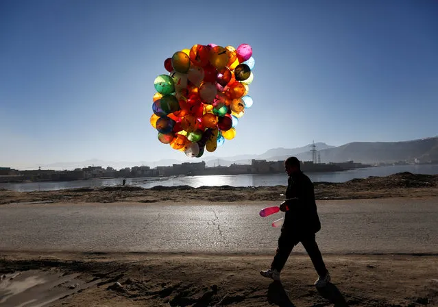 An Afghan man holds balloons for sale in Kabul, Afghanistan January 8, 2017. (Photo by Mohammad Ismail/Reuters)