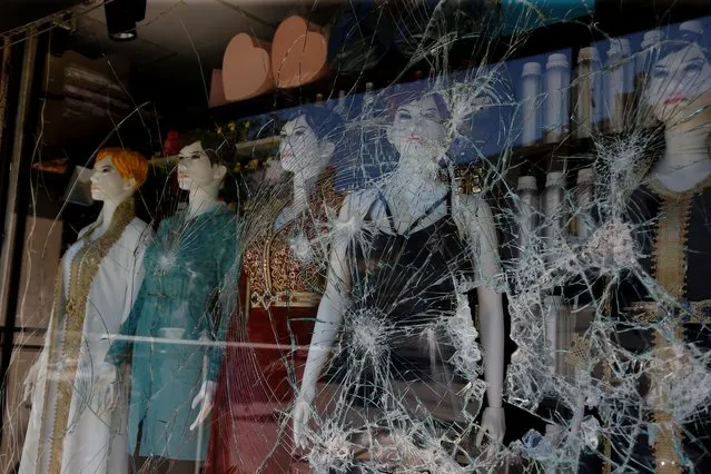 Mannequins are seen behind a broken window of a shop after a crowd of Turks attacked shops and homes belonging to Syrians overnight, in the wake of a street fight that led to a Turkish youth being fatally stabbed, in Ankara, Turkey on August 12, 2021. (Photo by Cagla Gurdogan/Reuters)