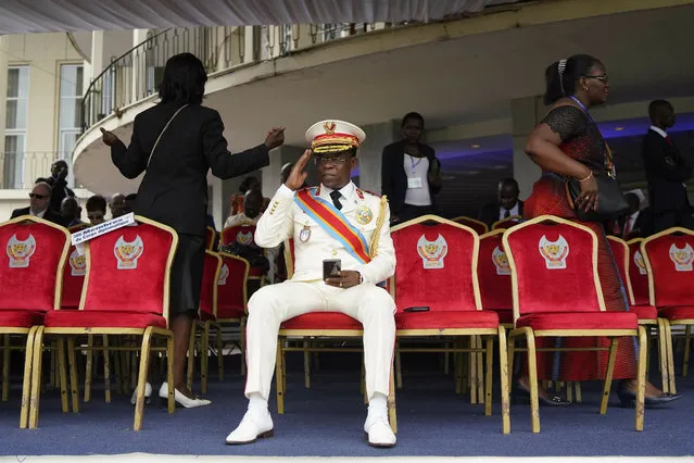 An officer salutes as he waits for other guests for Congolese President elect Felix Tshisekedi inauguration in Kinshasa, Democratic Republic of the Congo, Thursday January 24, 2019. Tshisekedi won an election that raised numerous concerns about voting irregularities amongst observers as the country chose a successor to longtime President Joseph Kabila. (Photo by Jerome Delay/AP Photo)