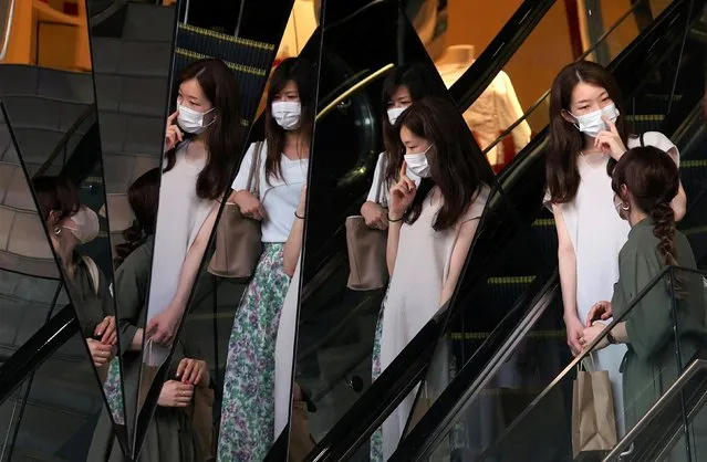 Women wearing protective masks, amid the coronavirus disease (COVID-19) outbreak, are reflected in mirrors at a shopping mall in Tokyo, Japan, August 5, 2021. (Photo by Kim Kyung-Hoon/Reuters)