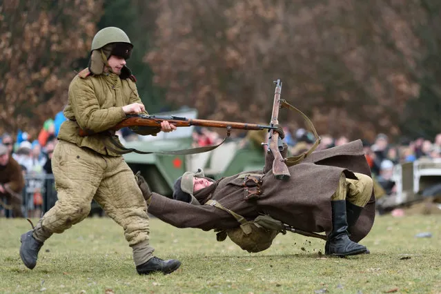 Members of a historical military club participate in the reenactment of “The Battle of Poznan” at the Citadel Park in Poznan, Poland, 21 February 2016. The Battle of Poznan during World War II in 1945 was a massive assault by the Soviet Union's Red Army that had as its objective the elimination of the Nazi German garrison in the stronghold city of Poznañ in occupied Poland. (Photo by Jakub Kaczmarczyk/EPA)