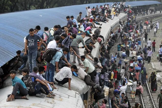 Bangladeshi Muslims climb onto the roof of an overcrowded train to travel to their hometowns ahead of of Eid al-Adha in Dhaka, Bangladesh, Tuesday, September 8, 2016. (Photo by A.M. Ahad/AP Photo)