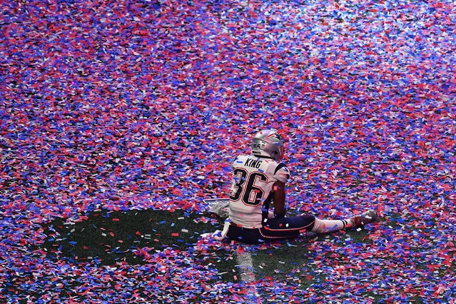 Brandon King of the New England Patriots sits in confetti on the pitch after winning Super Bowl LIII against the Los Angeles Rams at Mercedes-Benz Stadium in Atlanta, Georgia, on February 3, 2019. (Photo by Angela Weiss/AFP Photo)