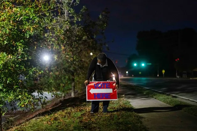 Veronica Blalock, 70, a first time poll worker, puts out a sign for voters at Worship With Wonders Church in Marietta, Ga., on Tuesday, November 8, 2022. (Photo by Kevin D. Liles for The Washington Post)