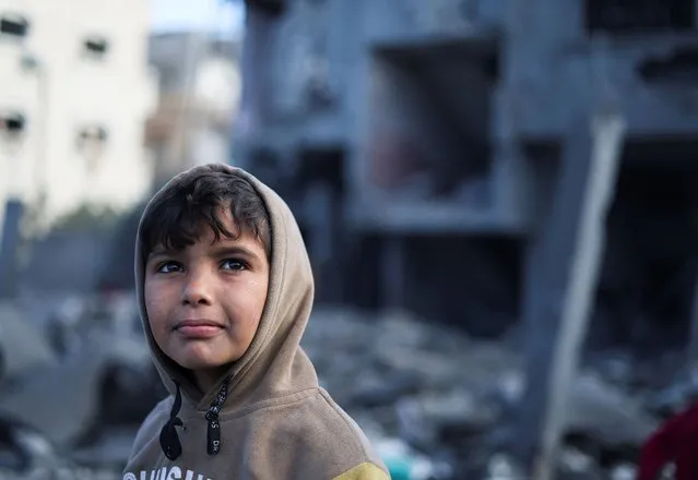 A Palestinian boy looks on, at the site of Israeli strikes on a mosque and houses, in Rafah in the southern Gaza Strip on January 25, 2024. (Photo by Ibraheem Abu Mustafa/Reuters)