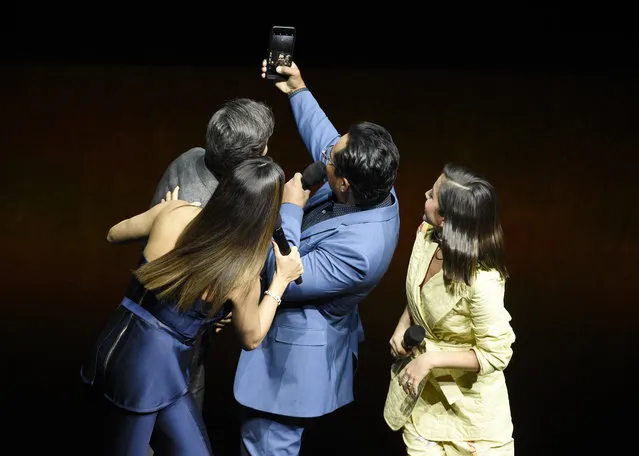 Michael Pena, second from right, a cast member in the upcoming film “Dora and the Lost City of Gold”, takes a selfie onstage with fellow cast members, from left, Eugenio Derbez, Eva Longoria and Isabela Moner during the Paramount Pictures presentation at CinemaCon 2019, the official convention of the National Association of Theatre Owners (NATO) at Caesars Palace, Thursday, April 4, 2019, in Las Vegas. (Photo by Chris Pizzello/Invision/AP Photo)
