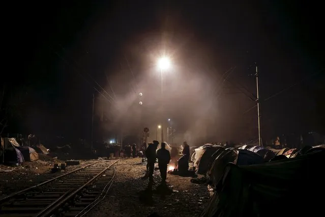 Refugees move among tents set next to railway tracks at a makeshift camp at the Greek-Macedonian border, near the village of Idomeni, Greece March 16, 2016. (Photo by Alkis Konstantinidis/Reuters)