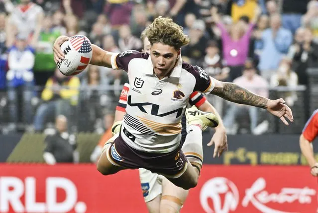 Broncos Reece Walsh is airborne as he scores a try during the NRL match between the Sydney Roosters and the Brisbane Broncos at Allegiant Stadium in Las Vegas, Saturday, March 2, 2024. (Photo by David Becker/AP Photo)