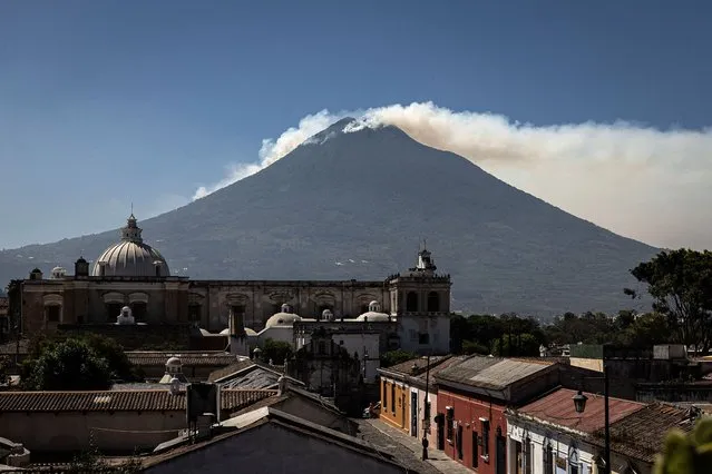 Smoke rises from a forest fire in the Agua Volcano near Antigua, Guatemala, 22 February 2024. El Agua is an inactive volcano with an altitude of 3,760 meters above sea level and is located a few kilometers from the colonial city of Antigua Guatemala, one of the main tourist sites in the Central American country. (Photo by David Toro/EPA)