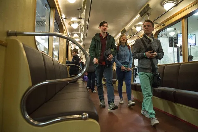 People walk in a Soviet-era vintage subway car, parked in the Partizanskaya subway station in Moscow, Russia, Friday, May 15, 2015. (Photo by Pavel Golovkin/AP Photo)
