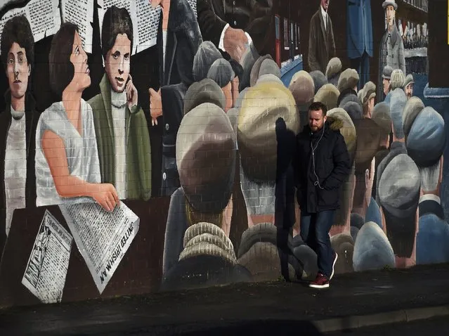 A man walks past a mural on the Falls Road a day after Northern Ireland's Deputy First Minister Martin McGuinness resigned, throwing the devolved joint administration into crisis, in Belfast Northern Ireland, January 10, 2017. (Photo by Clodagh Kilcoyne/Reuters)