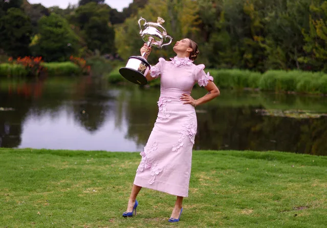 Belarus' Aryna Sabalenka poses with the 2023 Australian Open winner's trophy in Royal Botanic Garden in Melbourne on January 29, 2023, following her victory over Kazakhstan's Elena Rybakina in the women's singles final of the tennis tournament. (Photo by Carl Recine/Reuters)