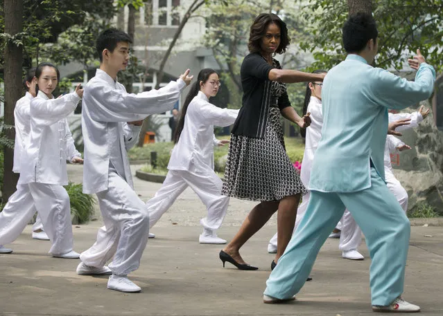 U.S. first lady Michelle Obama practices tai chi with students at Chengdu No.7 High School in Chengdu in southwest China's Sichuan province Tuesday, March 25, 2014. (Photo by Andy Wong/AP Photo)