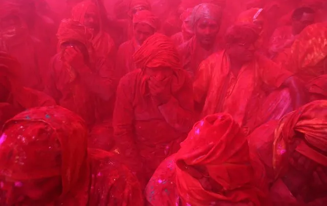 Hindu men from the village of Nandgaon celebrate covered with colored powder the Lathmar Holi festival at the Radha Rani temple in Barsana village, Mathura, India, 06 March 2017. (Photo by Rajat Gupta/EPA)