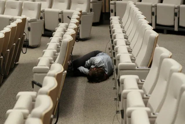 A journalist sleeps while waiting for the end of a European Union leaders summit that aims to select candidates for top EU institution jobs, in Brussels, Belgium on July 1, 2019. (Photo by Yves Herman/Reuters)